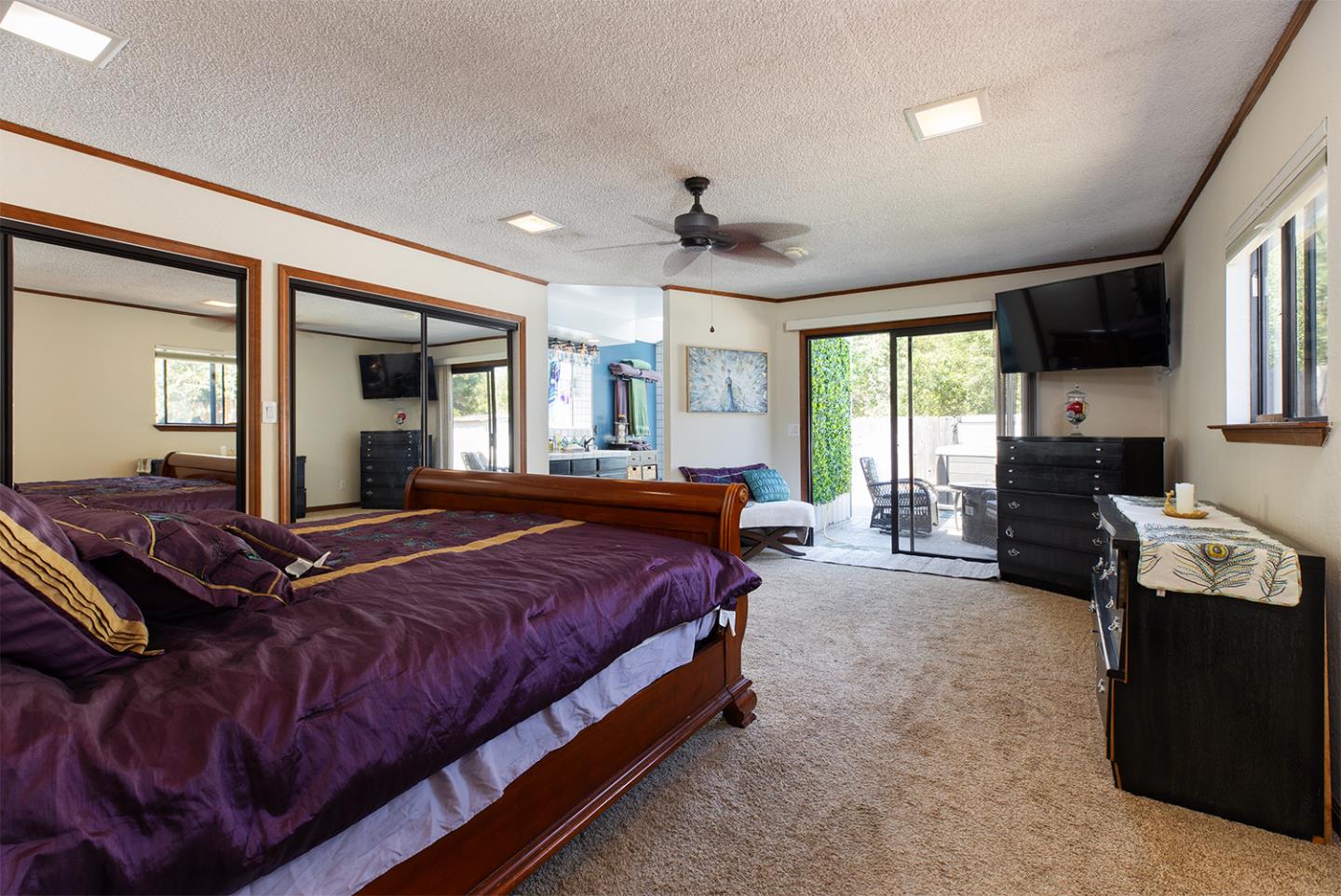 19220 Mallory Canyon Road Salinas, CA 93907 - Photo 18 of 29 a spacious bedroom with a bed and a chandelier