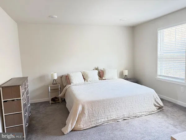 a bedroom with a bed and chair