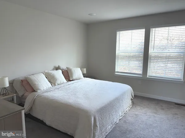 a bedroom with bed and a window