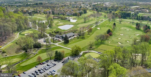 an aerial view of residential houses with outdoor space and swimming pool