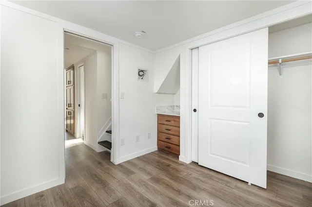 an empty room with wooden floor and closet
