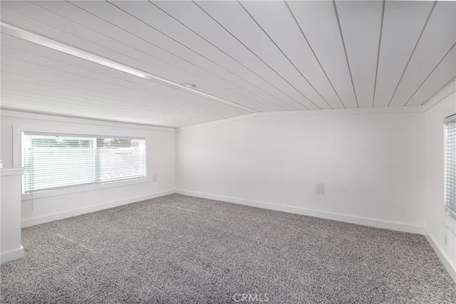 an empty room with a empty space and windows