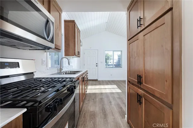a kitchen with wooden cabinets and a stove top oven