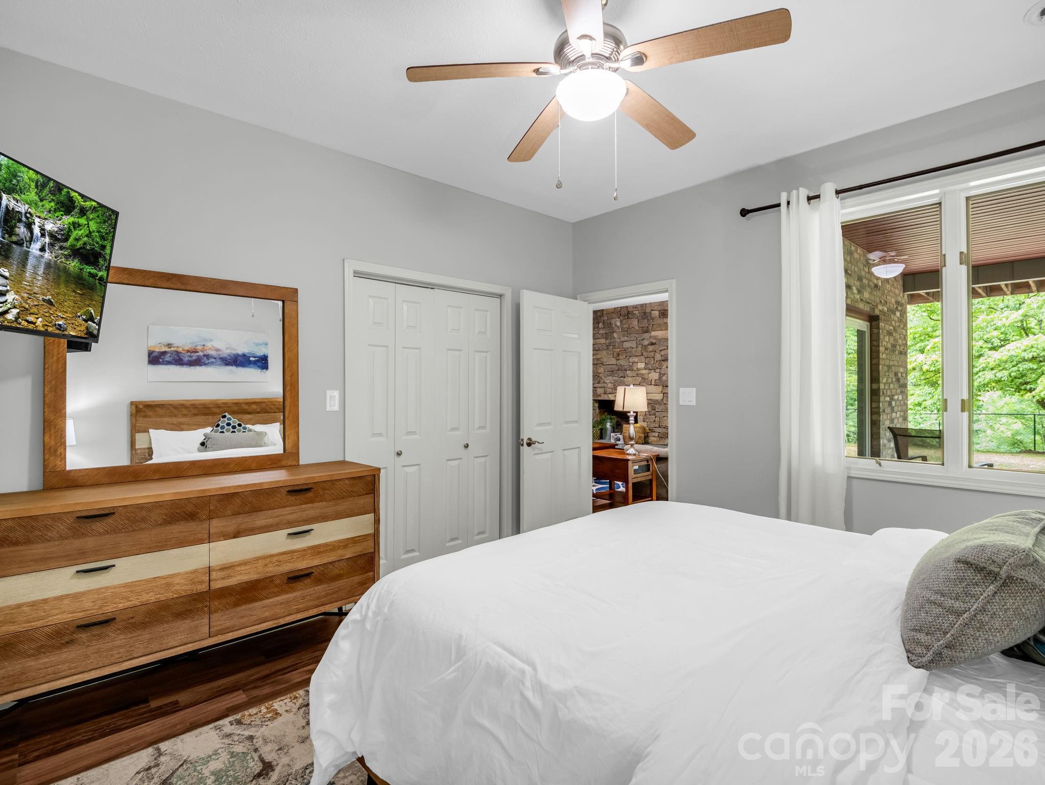 656 Cashiers Valley Road Brevard, NC 28712 - Photo 24 of 37 a bedroom with a bed and a flat screen tv