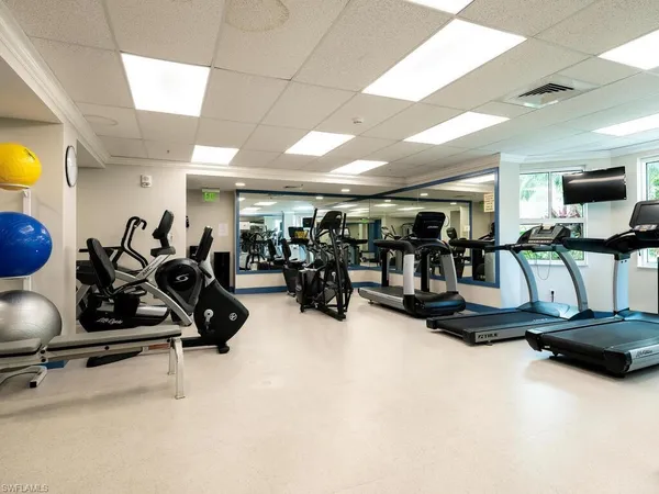 a room with gym equipment and a large window