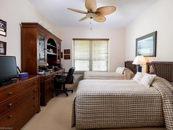 a bedroom with a bed and a desk