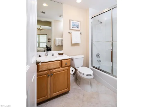 a bathroom with a toilet sink and shower