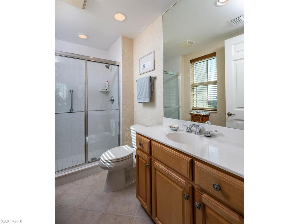 295 Grande Way, Unit 401 Naples, FL 34110 - Photo 10 of 19 a bathroom with a sink toilet and shower