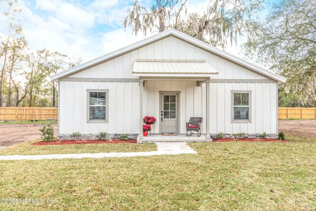a front view of a house with swimming pool and outdoor seating
