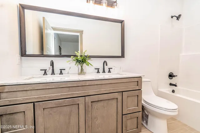 a bathroom with a sink a toilet and a mirror