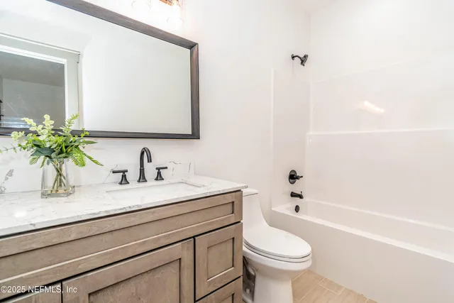 a bathroom with a sink a toilet and a bathtub