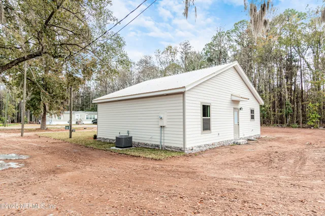 a view of a backyard with large trees