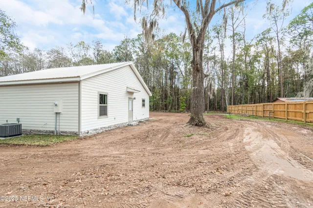 a view of a backyard with large trees