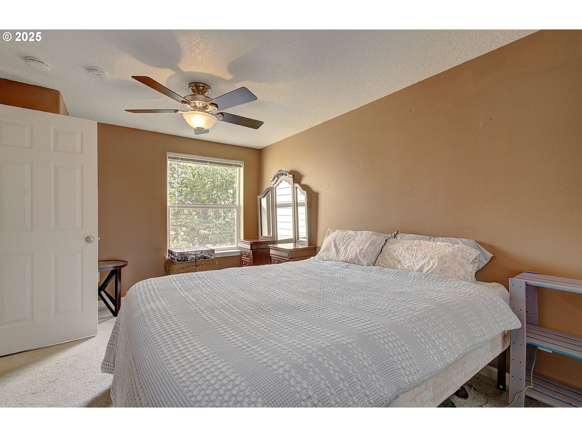 275 Southeast 162nd Avenue Portland, OR 97233 - Photo 16 of 22 a bedroom with a bed mirror and a window