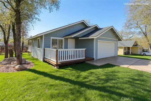 a living room with furniture a large window and a wooden floor