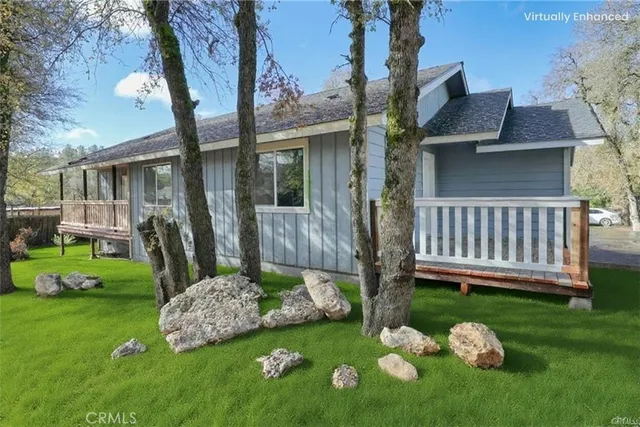a view of an empty room with wooden floor and windows