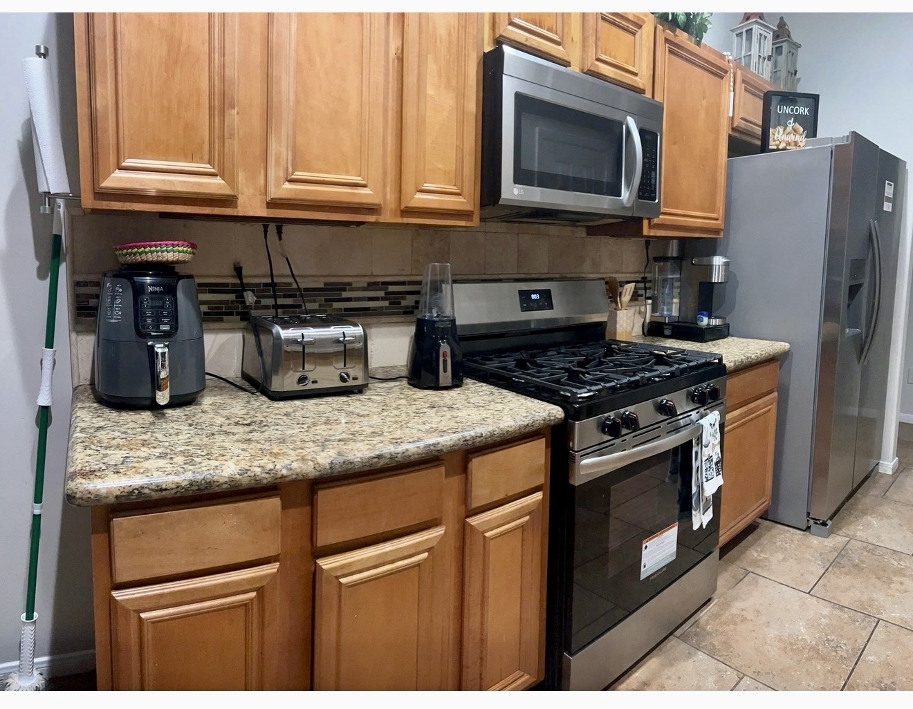 19331 Grand Colony Court Katy, TX 77449 - Photo 7 of 14 a kitchen with granite countertop a stove and a sink