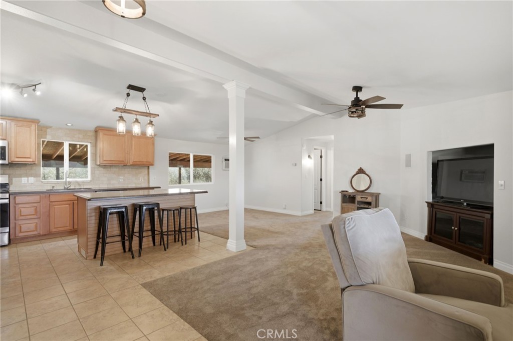 40100 Owl Valley Road Temecula, CA 92592 - Photo 29 of 44 a living room with furniture a dining table and kitchen view