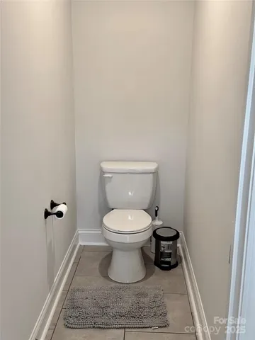 a bathroom with a toilet and a rug