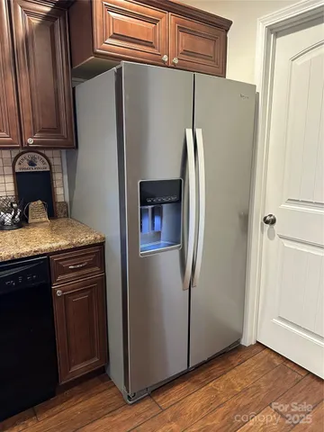 a kitchen with metallic refrigerator and sink