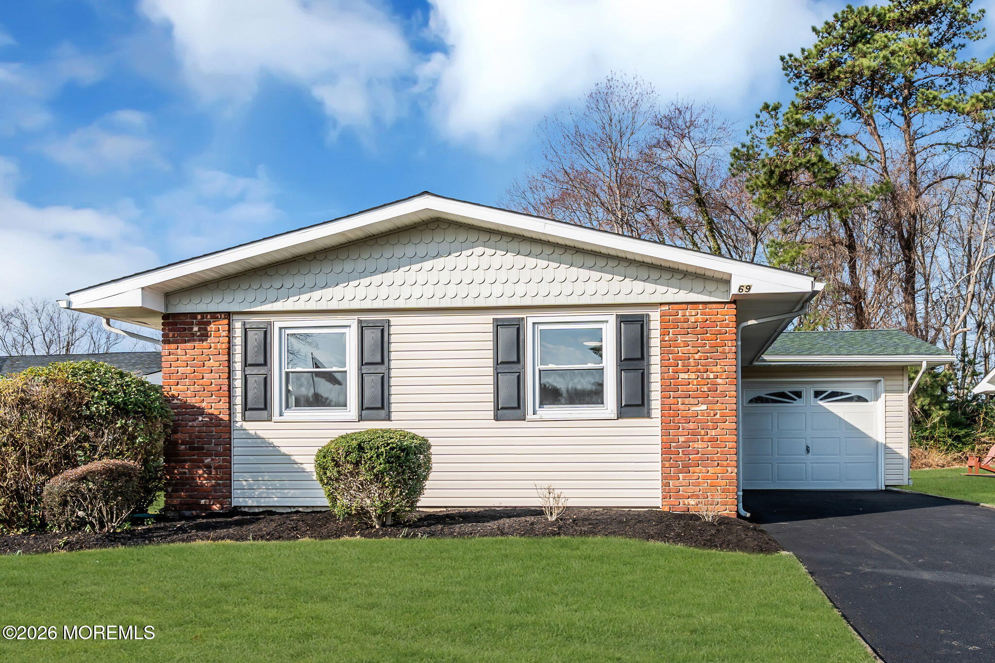 69 Clay Circle Brick, NJ 08724 - Photo 1 of 27 a front view of a house with a garden and plants