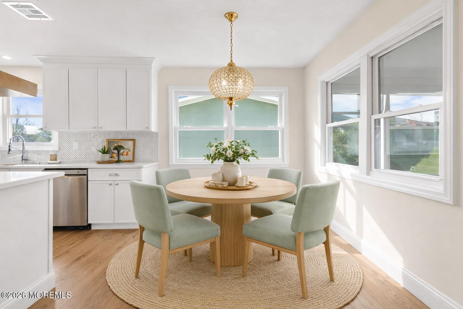 69 Clay Circle Brick, NJ 08724 - Photo 12 of 27 a dining room with furniture a chandelier and wooden floor