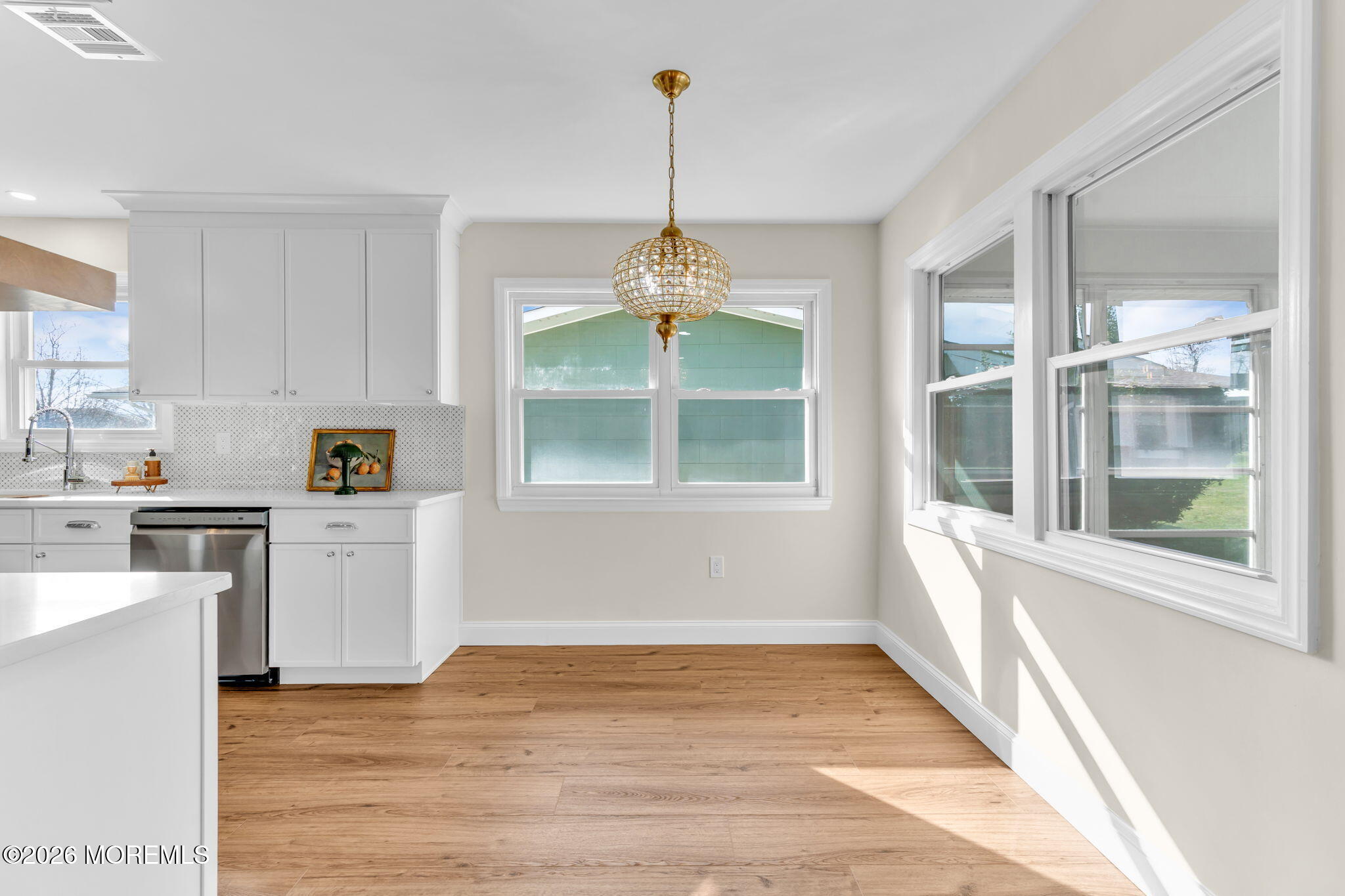 69 Clay Circle Brick, NJ 08724 - Photo 13 of 27 a kitchen with a window and wooden floor