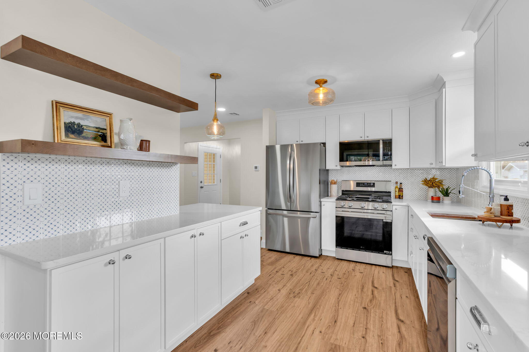 69 Clay Circle Brick, NJ 08724 - Photo 15 of 27 a kitchen with white cabinets and stainless steel appliances