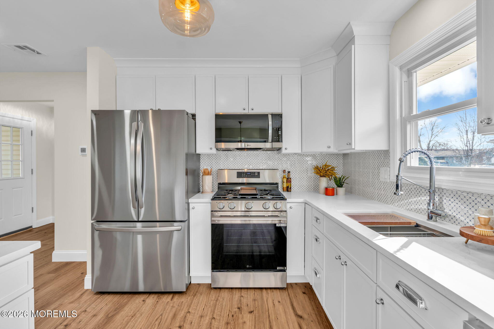69 Clay Circle Brick, NJ 08724 - Photo 16 of 27 a kitchen with a stove a refrigerator and a sink