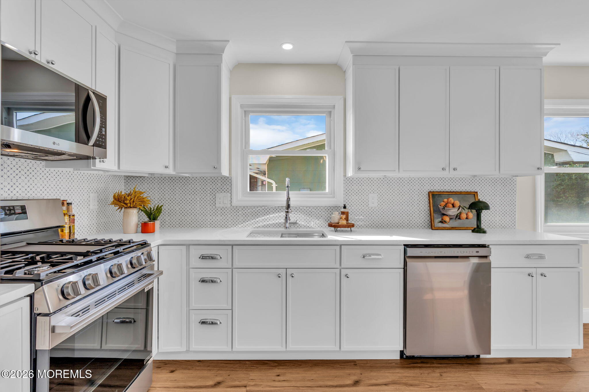 69 Clay Circle Brick, NJ 08724 - Photo 17 of 27 a kitchen with stainless steel appliances white cabinets and a stove top oven