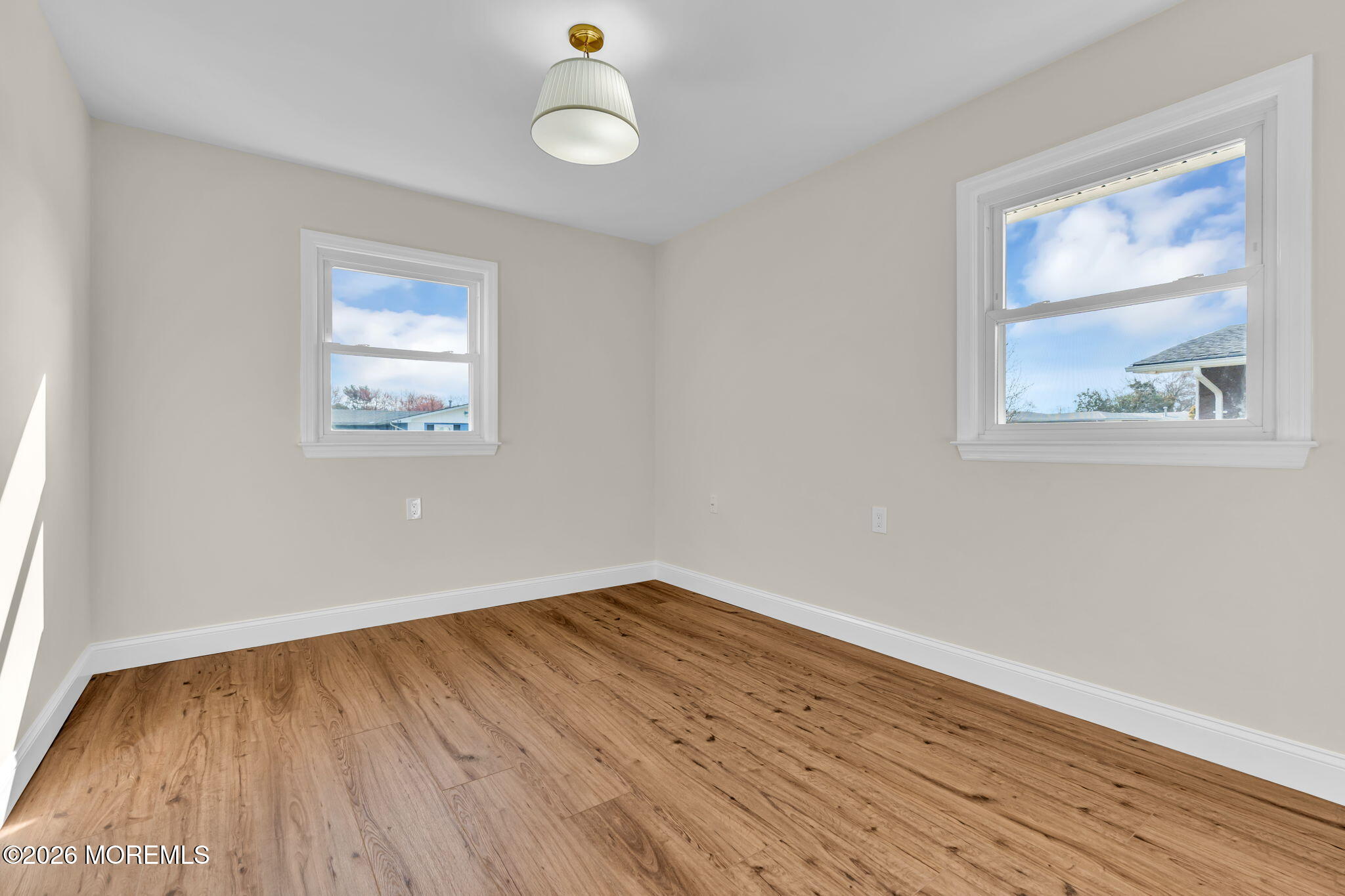 69 Clay Circle Brick, NJ 08724 - Photo 20 of 27 an empty room with wooden floor and windows