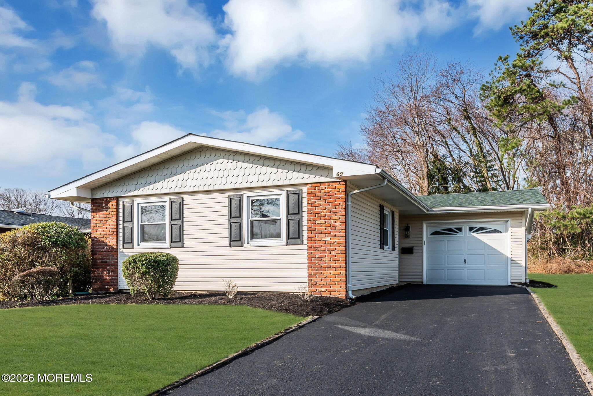 69 Clay Circle Brick, NJ 08724 - Photo 2 of 27 a front view of a house with a yard and garage