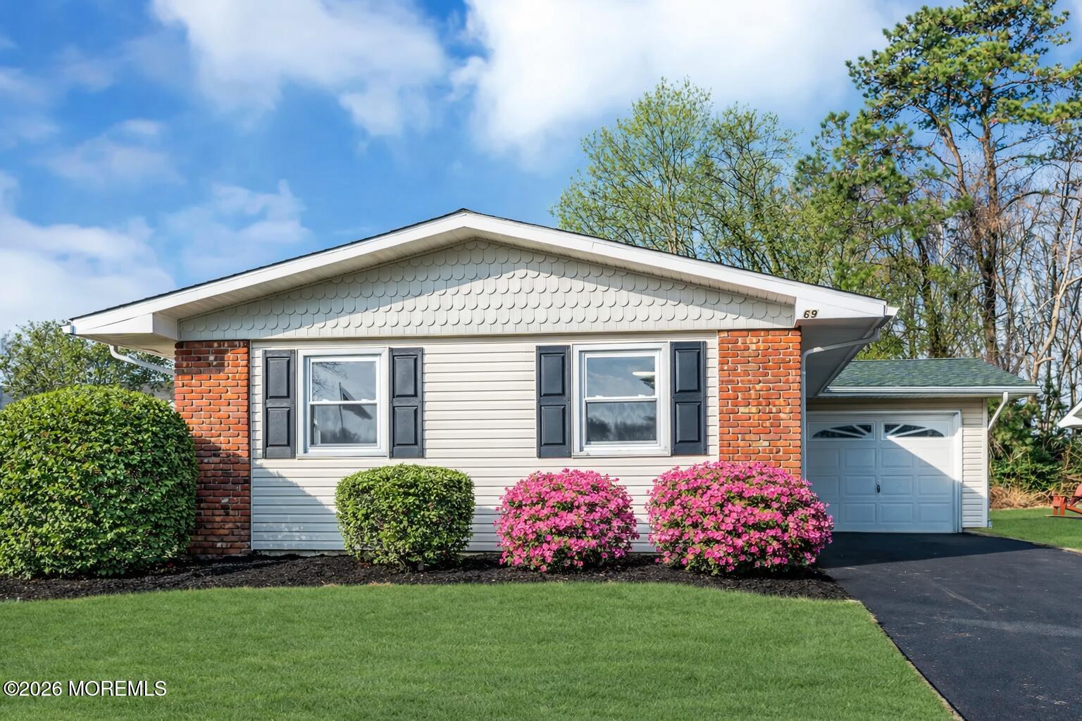 69 Clay Circle Brick, NJ 08724 - Photo 27 of 27 a front view of a house with a garden