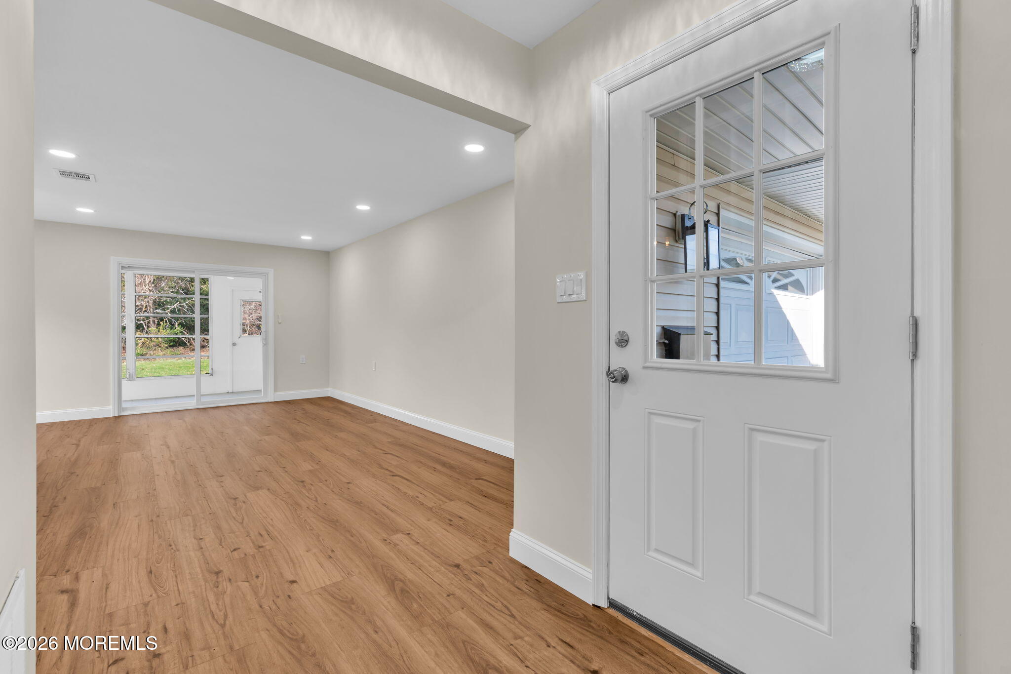 69 Clay Circle Brick, NJ 08724 - Photo 4 of 27 a view of an empty room with wooden floor and a window