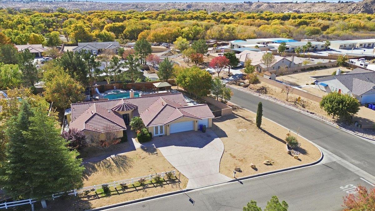 an aerial view of a house with a swimming pool