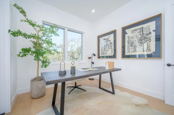 a view of a livingroom with furniture and a potted plant
