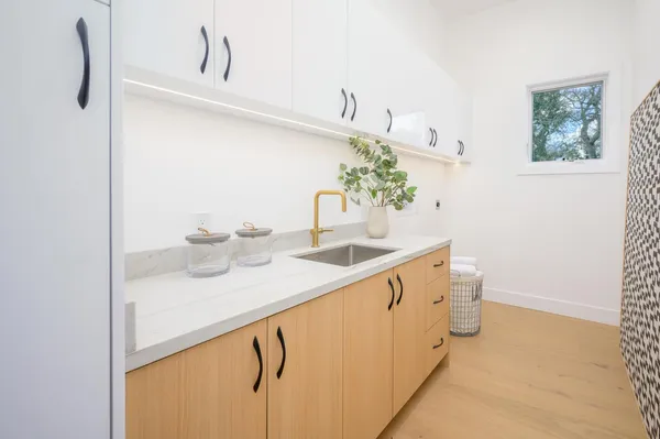 a front view of a house with a yard glass top table and chairs