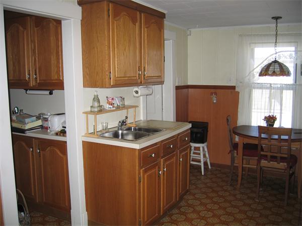 26 Wintworth Street Chicopee, MA 01013 - Photo 4 of 13 a kitchen with appliances cabinets and furniture