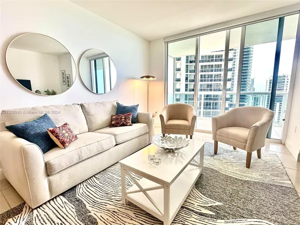 a living room with furniture and a large window