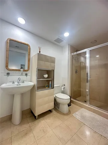a bathroom with a sink toilet and shower