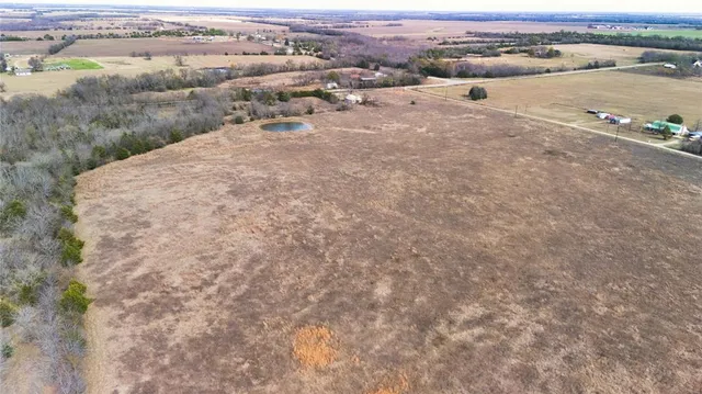 an aerial view of a houses with a yard
