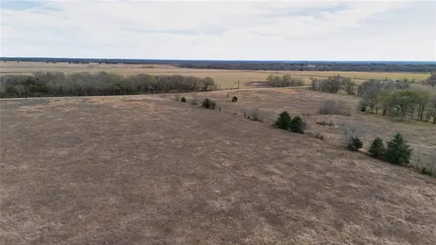 a view of a field with ocean view