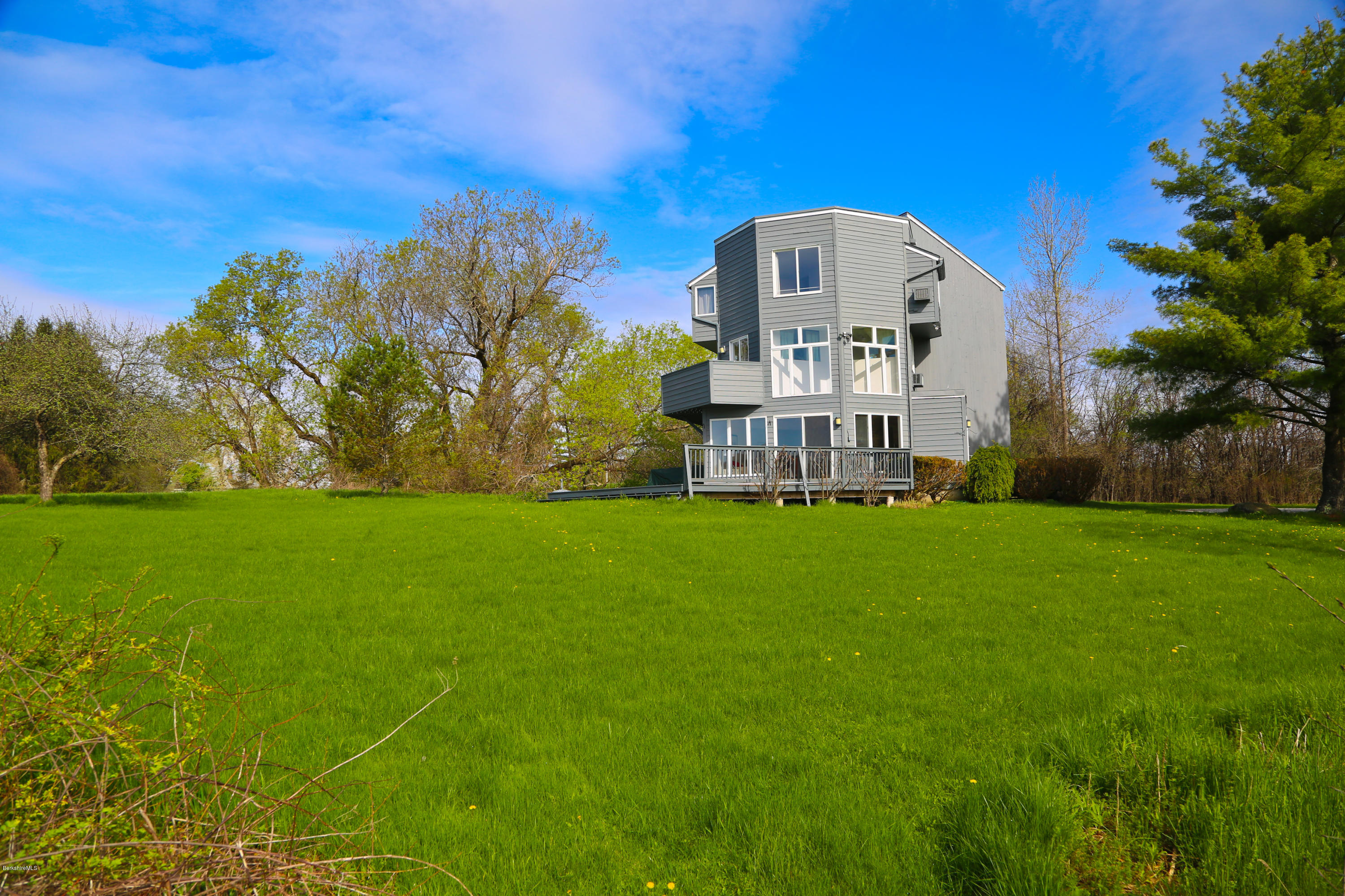 29 Rattlesnake Mountain Road Stockbridge, MA 01262 - Photo 4 of 21 a view of a big yard with a house in the background