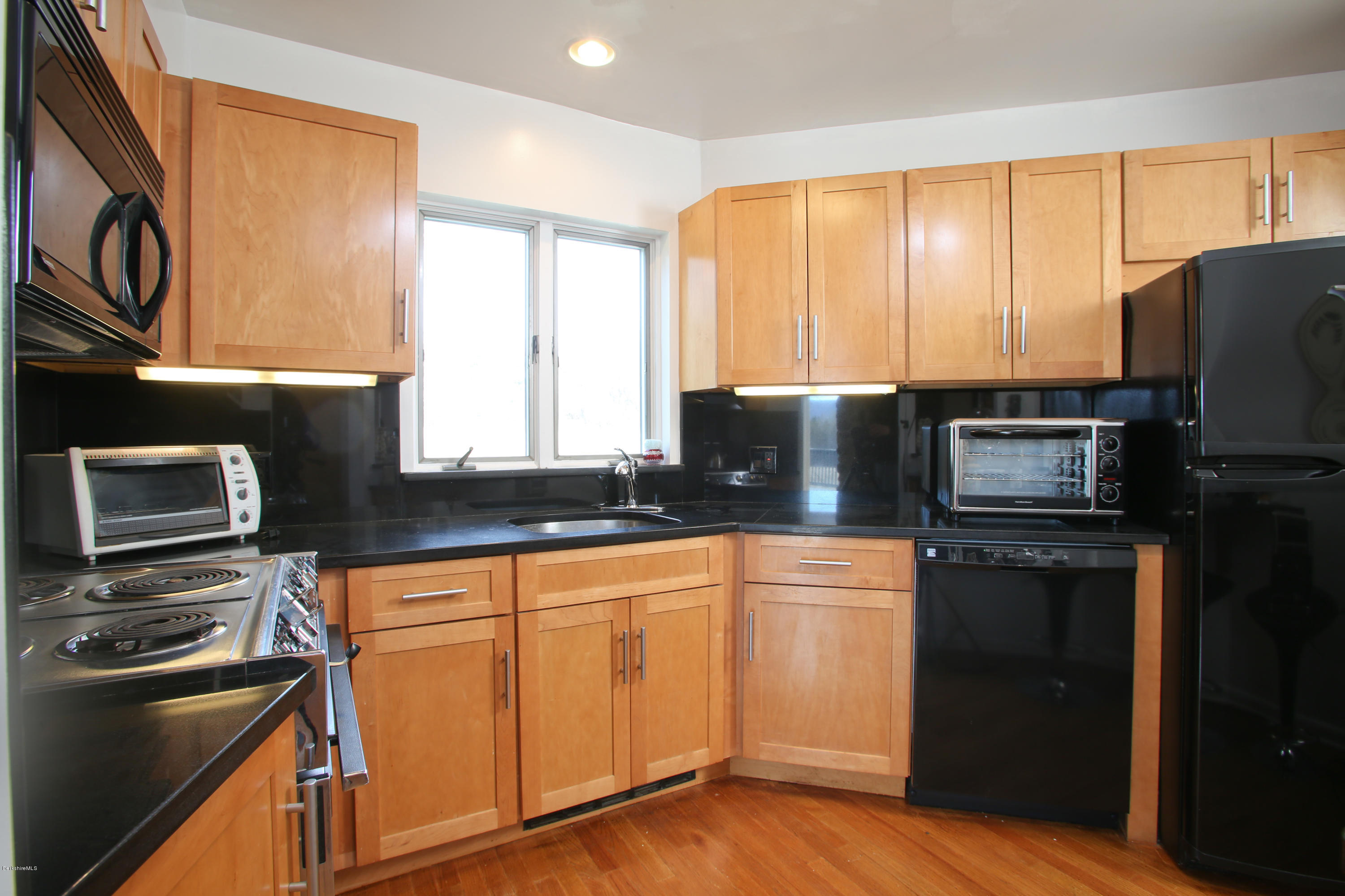 29 Rattlesnake Mountain Road Stockbridge, MA 01262 - Photo 7 of 21 a kitchen with granite countertop a refrigerator stove top oven and sink