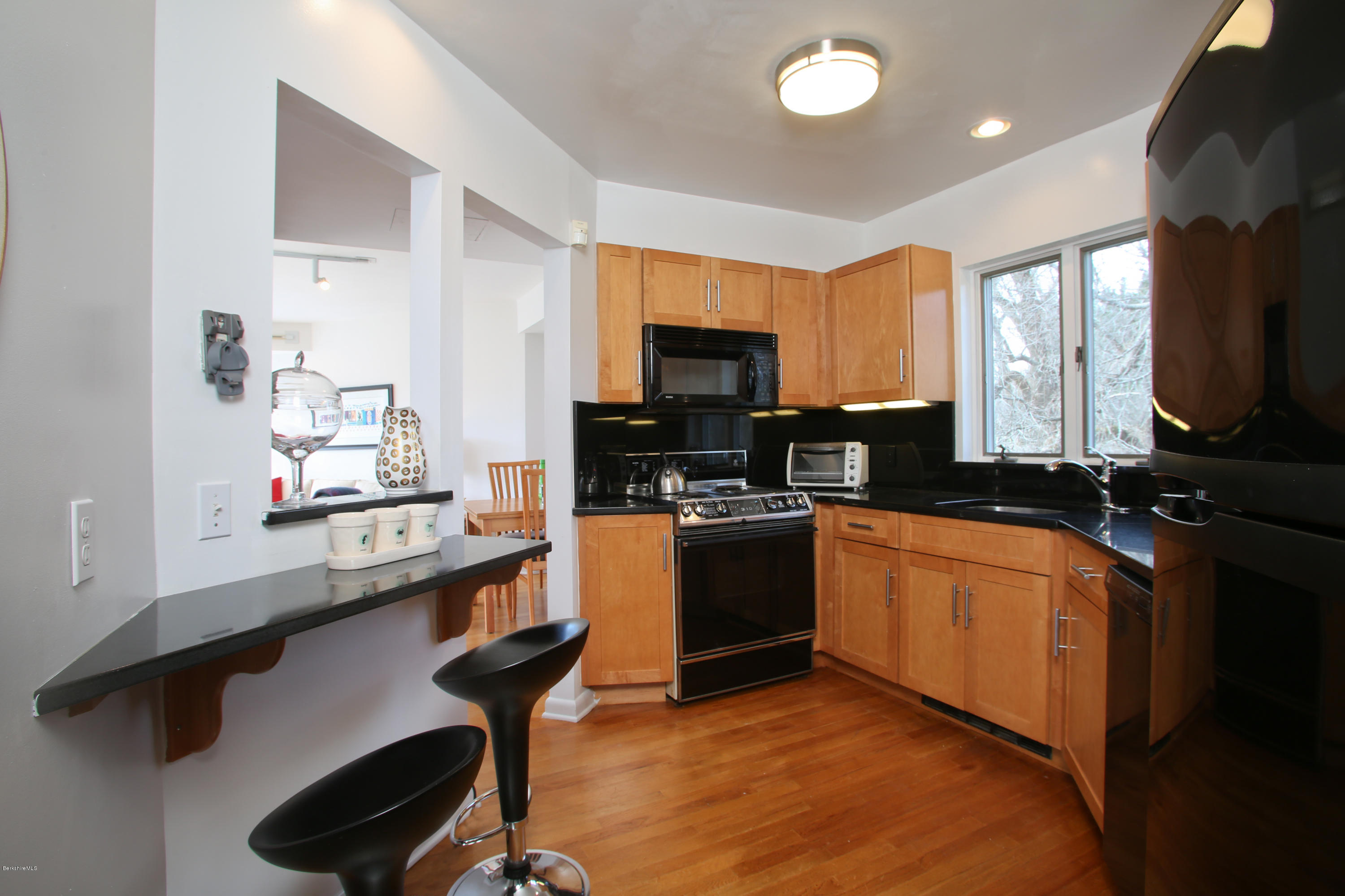 29 Rattlesnake Mountain Road Stockbridge, MA 01262 - Photo 8 of 21 a kitchen with stainless steel appliances granite countertop a sink dishwasher stove and microwave
