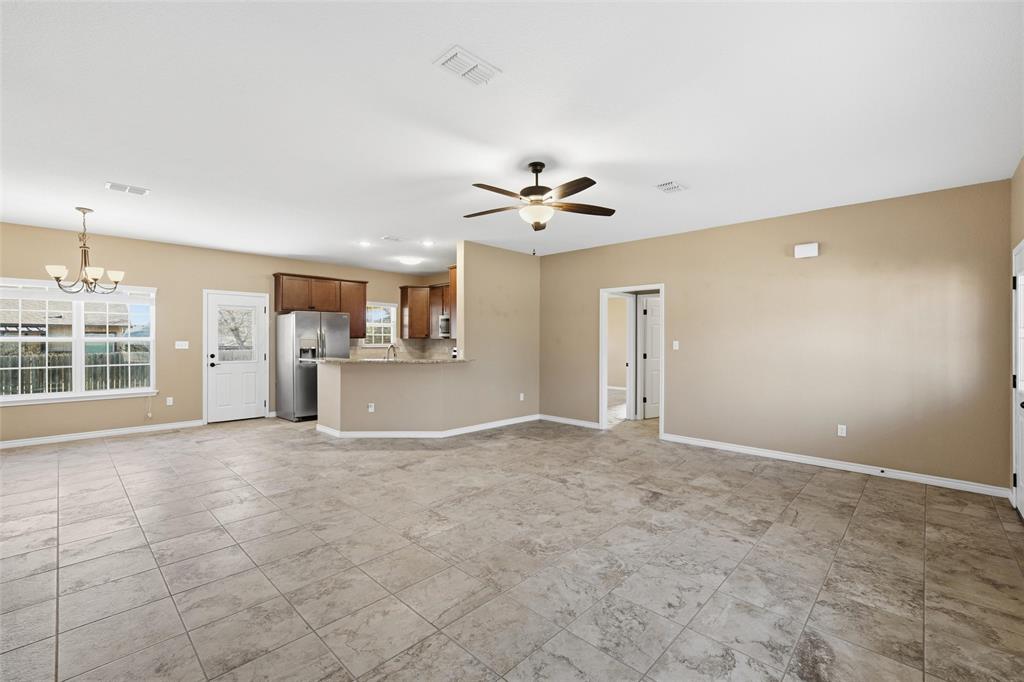 37 Buckskin Loop Belton, TX 76513 - Photo 3 of 25 an empty room with a kitchen and a ceiling fan window