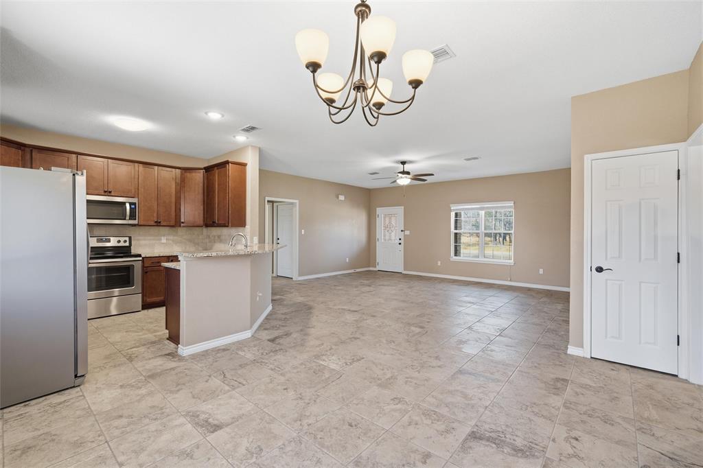 37 Buckskin Loop Belton, TX 76513 - Photo 8 of 25 a view of a kitchen with a sink and stainless steel appliances