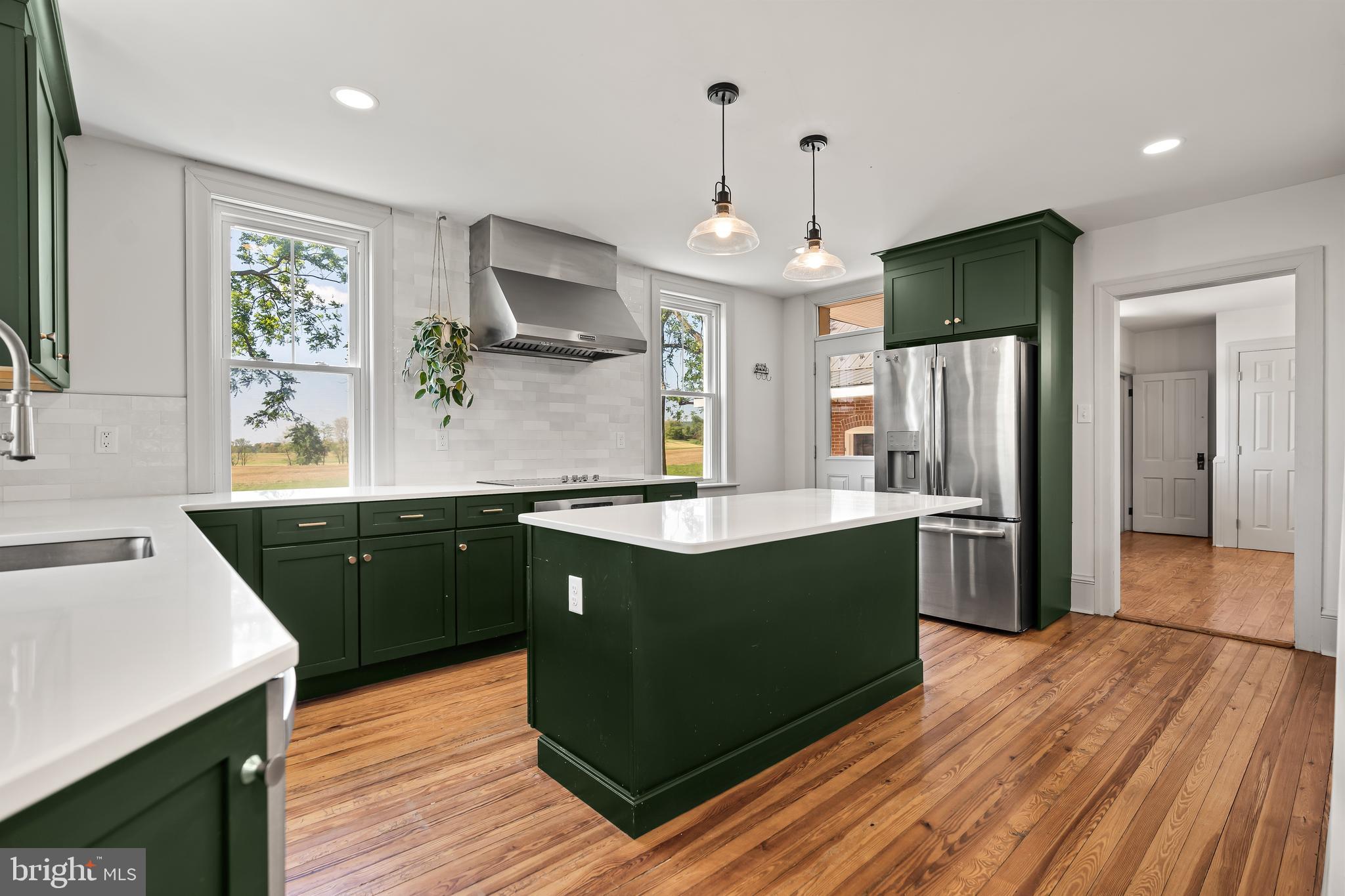 14005 Dry Run Road Clear Spring, MD 21722 - Photo 15 of 44 a kitchen with stainless steel appliances granite countertop a refrigerator a sink dishwasher a kitchen island with wooden cabinets and floor