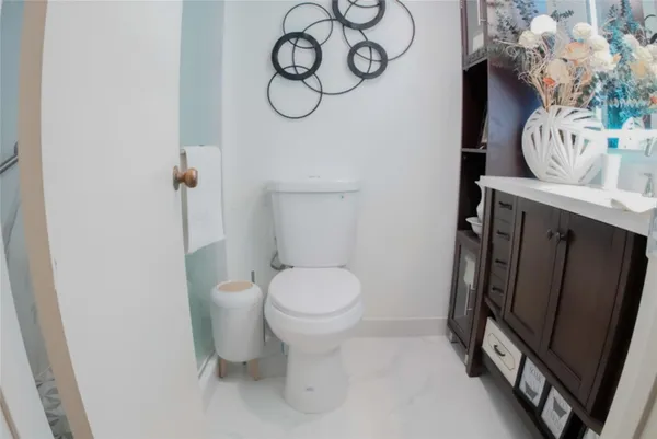 a bathroom with a toilet and a mirror