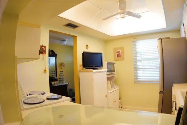 a living room with a bed furniture and a flat screen tv